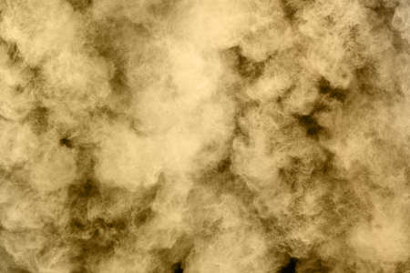 Golden powder explosion on black background. Freeze motion.
