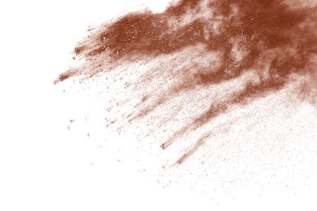 Brown color powder explosion on white background. Colored cloud. Colorful dust explode. Paint Holi.の写真素材