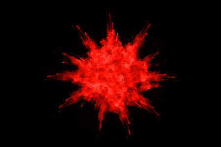 abstract red powder explosion on black background.abstract red powder splatted on black background....