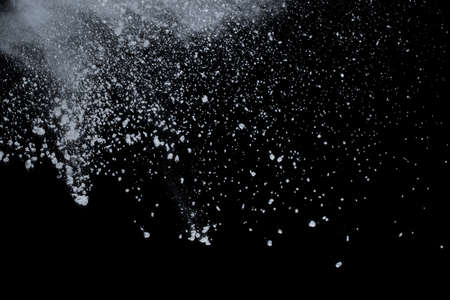White powder explosion on black background. Colored cloud. Colorful dust explode. Paint Holi.の写真素材