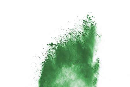 Green powder explosion on white background. Colored cloud. Colorful dust explode. Paint Holi.の写真素材