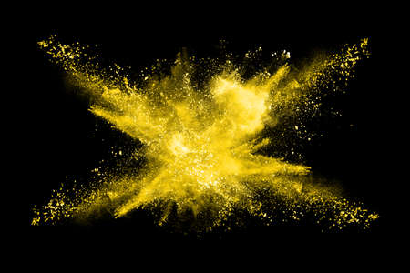 Freeze motion of yellow dust explosion isolated on black background.
