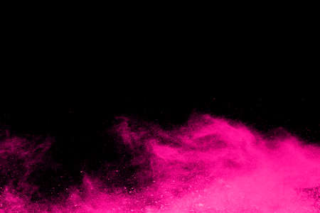 Pink powder explosion on black background. Colored cloud. Colorful dust explode. Paint Holi.