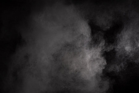 White powder explosion on black background. Colored cloud. Colorful dust explode. Paint Holi.
