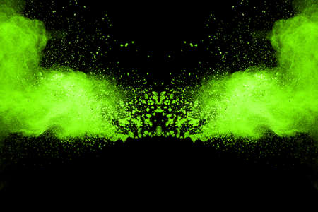 The movement of abstract dust explosion frozen green on black background. Stop the movement of...