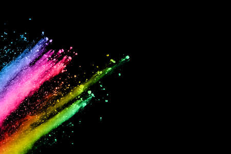 abstract colored dust explosion on a black background.abstract powder splatted background,Freeze motion of color powder exploding/throwing color powder, multicolored glitter texture.の写真素材