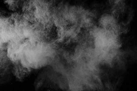 White powder explosion on black background. Colored cloud. Colorful dust explode. Paint Holi.