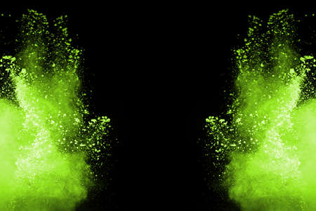 The movement of abstract dust explosion frozen green on black background. Stop the movement of...