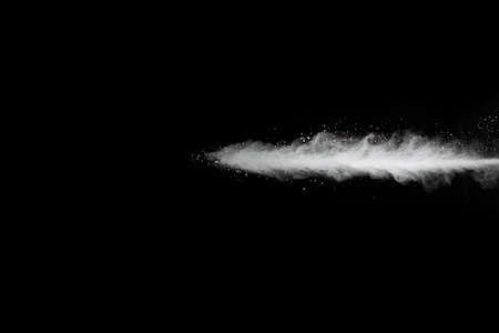 White powder explosion on black background. Colored cloud. Colorful dust explode. Paint Holi.の写真素材