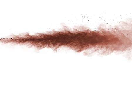 Brown color powder explosion on white background. Colored cloud. Colorful dust explode. Paint Holi.の写真素材