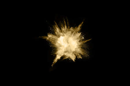 Golden powder explosion on black background. Freeze motion.の写真素材