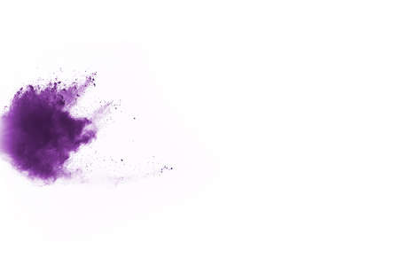 Powder explosion. Closeup of a purple dust particle explosion isolated on white. Abstract background.の写真素材