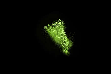 The movement of abstract dust explosion frozen green on black background. Stop the movement of powdered green on black background. Explosive powder green on black background.の写真素材