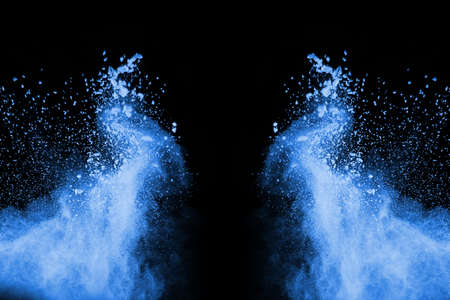 Blue powder explosion on black background. Colored cloud. Colorful dust explode. Paint Holi.