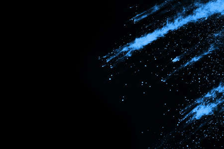 Blue powder explosion on black background. Colored cloud. Colorful dust explode. Paint Holi.