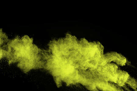 The movement of abstract dust explosion frozen green on black background. Stop the movement of powdered green on black background. Explosive powder green on black background.の写真素材