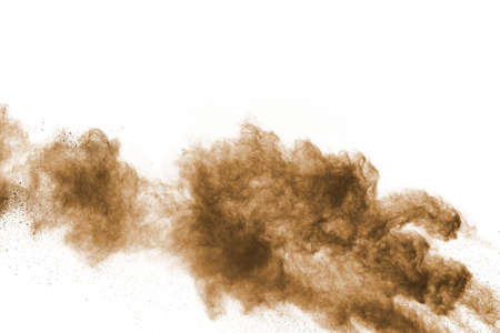 Brown color powder explosion on white background. Colored cloud. Colorful dust explode. Paint Holi.