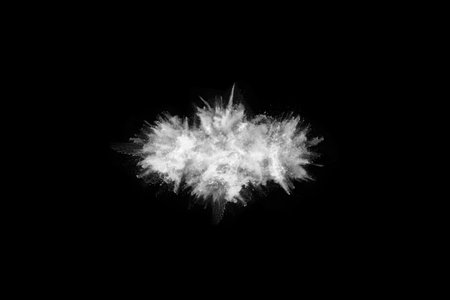 White powder explosion on black background. Colored cloud. Colorful dust explode. Paint Holi.の写真素材