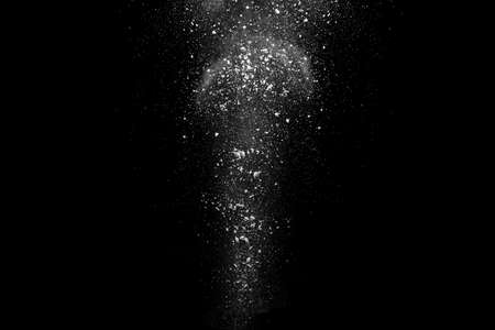 White powder explosion on black background. Colored cloud. Colorful dust explode. Paint Holi.の写真素材