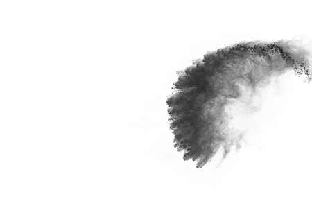 Particles of charcoal on white background,abstract powder splatted on white background,Freeze motion...