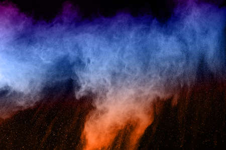 abstract colored dust explosion on a black background.abstract powder splatted background,Freeze...