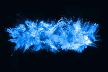 Blue powder explosion on black background. Colored cloud. Colorful dust explode. Paint Holi.の写真素材
