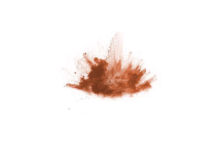Brown color powder explosion on white background. Colored cloud. Colorful dust explode. Paint Holi.