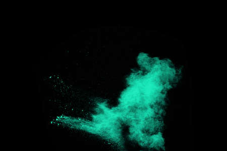 Blue powder explosion on black background. Colored cloud. Colorful dust explode. Paint Holi.の写真素材