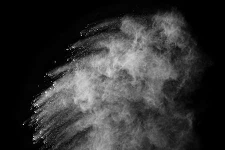 White powder explosion on black background. Colored cloud. Colorful dust explode. Paint Holi.