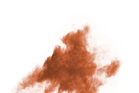 Brown color powder explosion on white background. Colored cloud. Colorful dust explode. Paint Holi.の写真素材
