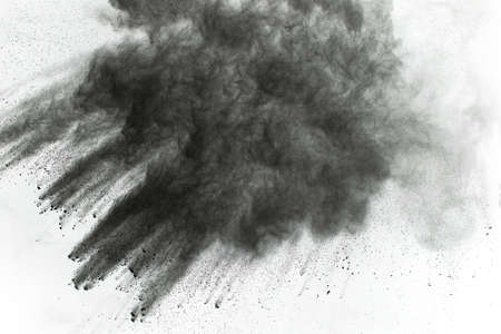 Particles of charcoal on white background,abstract powder splatted on white background,Freeze motion...