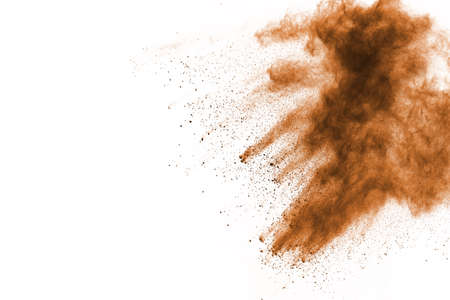 Brown color powder explosion on white background. Colored cloud. Colorful dust explode. Paint Holi.の写真素材