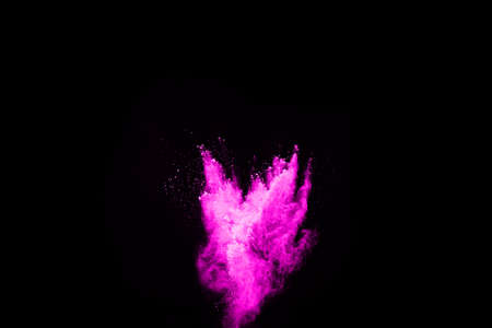 Pink powder explosion on black background. Colored cloud. Colorful dust explode. Paint Holi.