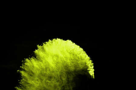 The movement of abstract dust explosion frozen green on black background. Stop the movement of...