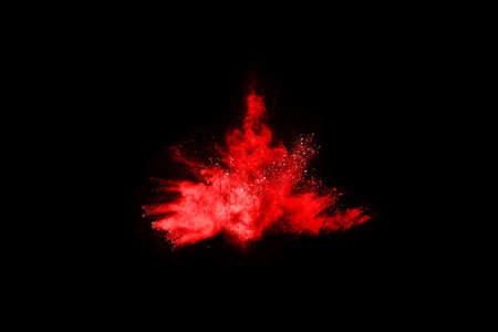 abstract red powder explosion on black background.abstract red powder splatted on black background. Freeze motion of red powder exploding.の写真素材