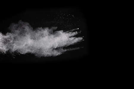 White powder explosion on black background. Colored cloud. Colorful dust explode. Paint Holi.