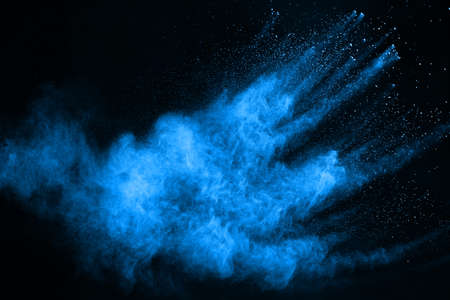 Blue powder explosion on black background. Colored cloud. Colorful dust explode. Paint Holi.