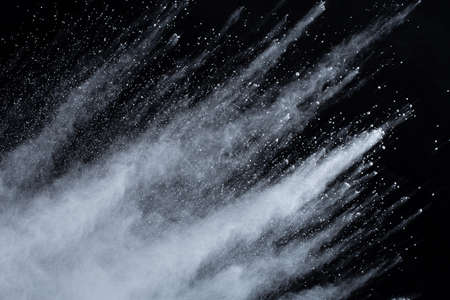 White powder explosion on black background. Colored cloud. Colorful dust explode. Paint Holi.