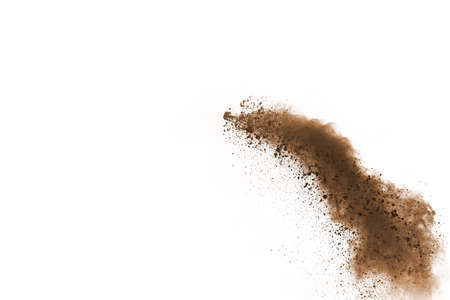 Brown color powder explosion on white background. Colored cloud. Colorful dust explode. Paint Holi.の写真素材