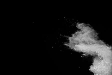 White powder explosion on black background. Colored cloud. Colorful dust explode. Paint Holi.の写真素材