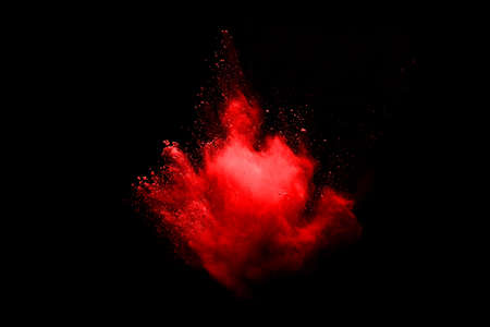 abstract red powder explosion on black background.abstract red powder splatted on black background....