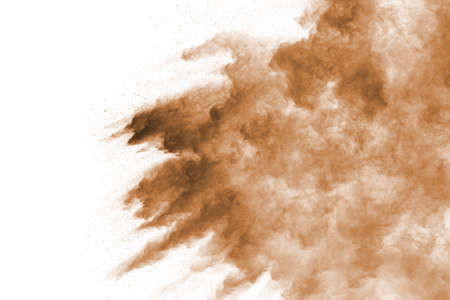 Brown color powder explosion on white background. Colored cloud. Colorful dust explode. Paint Holi.の写真素材