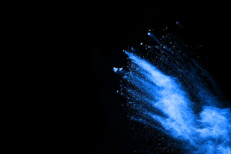 Blue powder explosion on black background. Colored cloud. Colorful dust explode. Paint Holi.