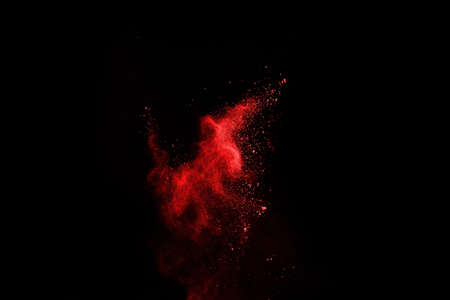 abstract red powder explosion on black background.abstract red powder splatted on black background. Freeze motion of red powder exploding.の写真素材