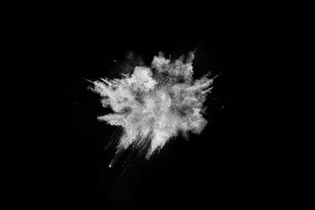 White powder explosion on black background. Colored cloud. Colorful dust explode. Paint Holi.の写真素材