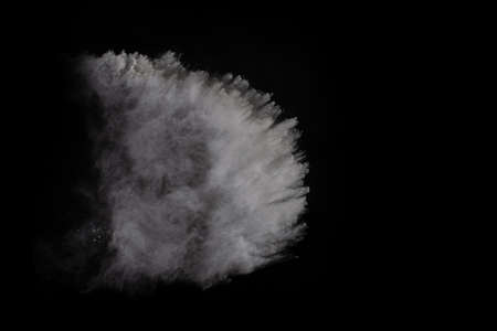 White powder explosion on black background. Colored cloud. Colorful dust explode. Paint Holi.