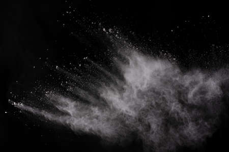 White powder explosion on black background. Colored cloud. Colorful dust explode. Paint Holi.