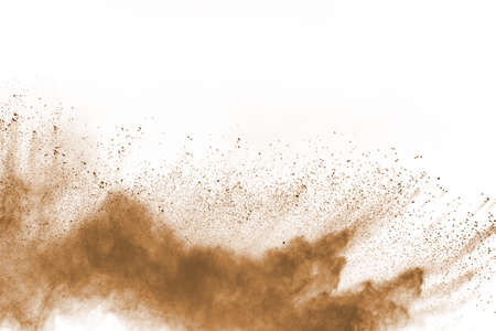 Brown color powder explosion on white background. Colored cloud. Colorful dust explode. Paint Holi.の写真素材