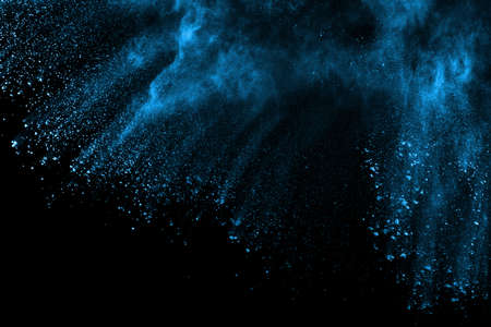 Blue powder explosion on black background. Colored cloud. Colorful dust explode. Paint Holi.