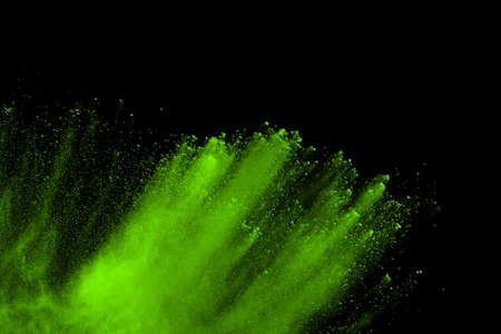 The movement of abstract dust explosion frozen green on black background. Stop the movement of...